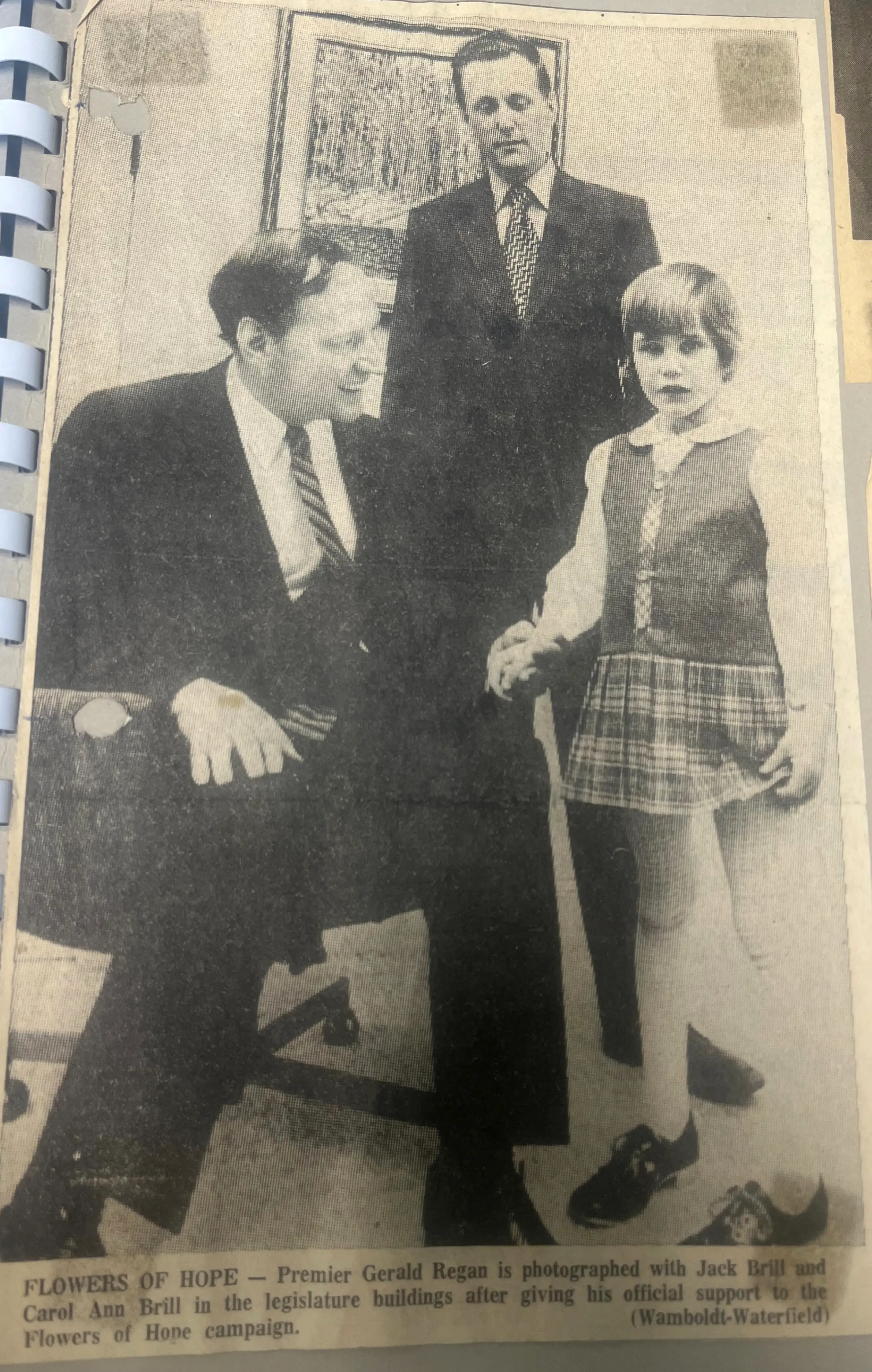newspaper clipping showing Premier Geoff Regan with Jack Brill and Carol Ann Brill